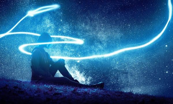 Person resting under a starry night sky, wrapped with a glowing trail of light